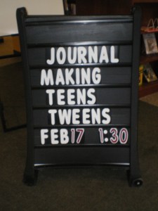 Recycled journal making class sign at the Sixteen Acres library!